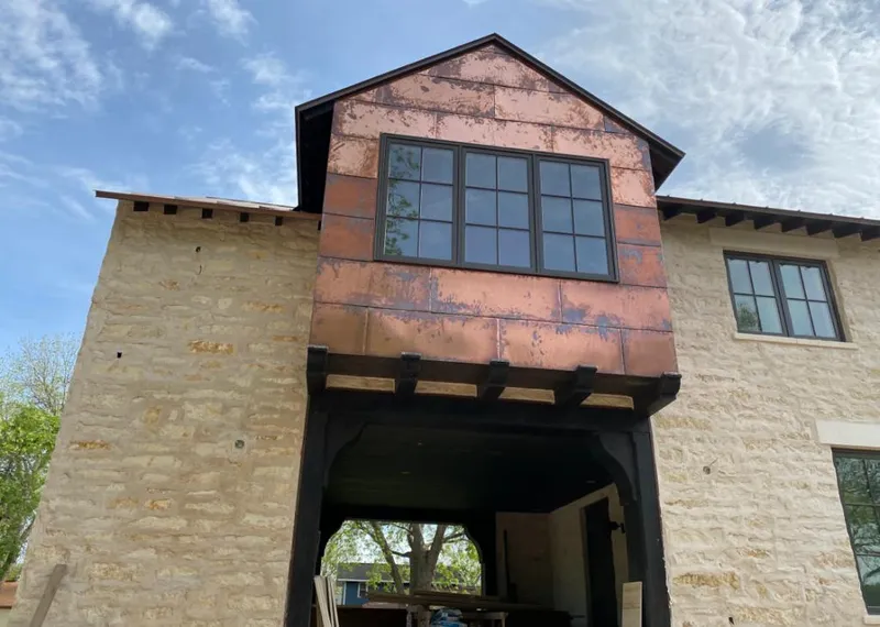 Copper metal panel facade on a stone building for Skylight Installation in Highland Park